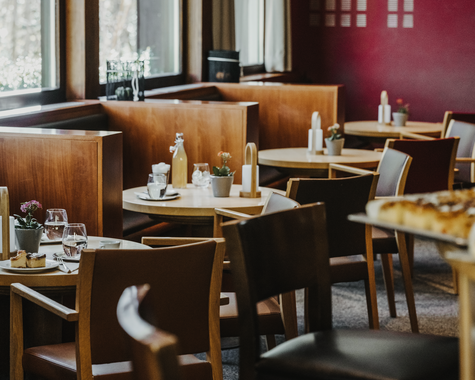 Gemütlicher Restaurantbereich mit gedeckten Tischen und Sitzgelegenheiten.