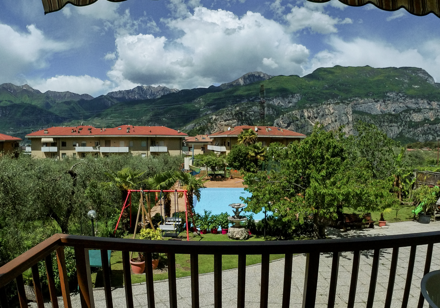 Blick vom Balkon auf Pool, Garten und Berge